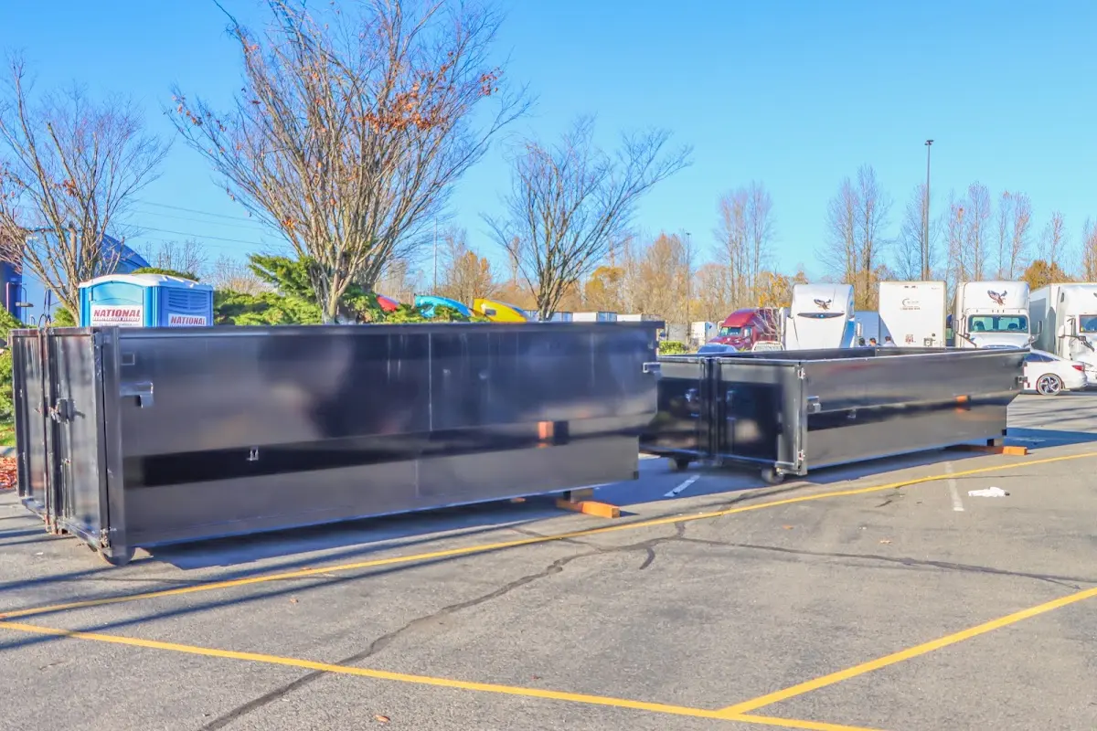 Professional dumpster rental service with roll-off container on residential driveway in Clover Creek